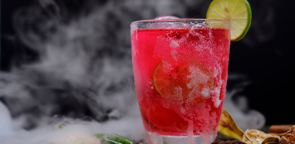 Fruit punch mocktail with lime and salt on the glass.