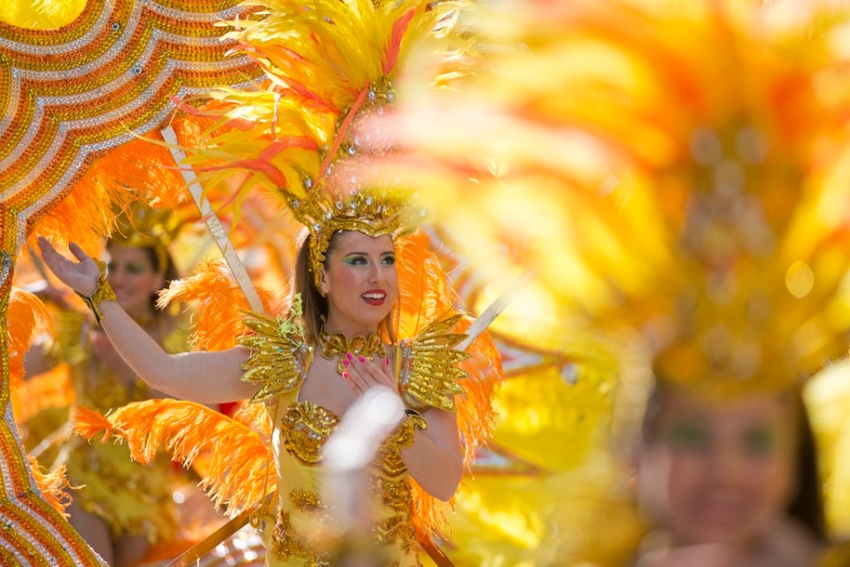 Unidentified woman dressed as dancer marching during the parade of the Lemon Festival