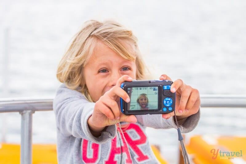 young girl taking selfie with camera