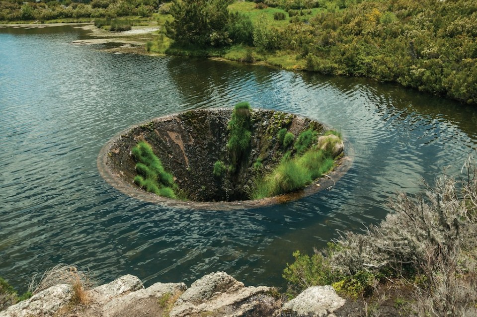 Large sinkhole constructed as a water spillway at the Covao dos Conchos dam lake on the highlands of the Serra da Estrela. The highest mountain range in continental Portugal, with astonishing scenery.