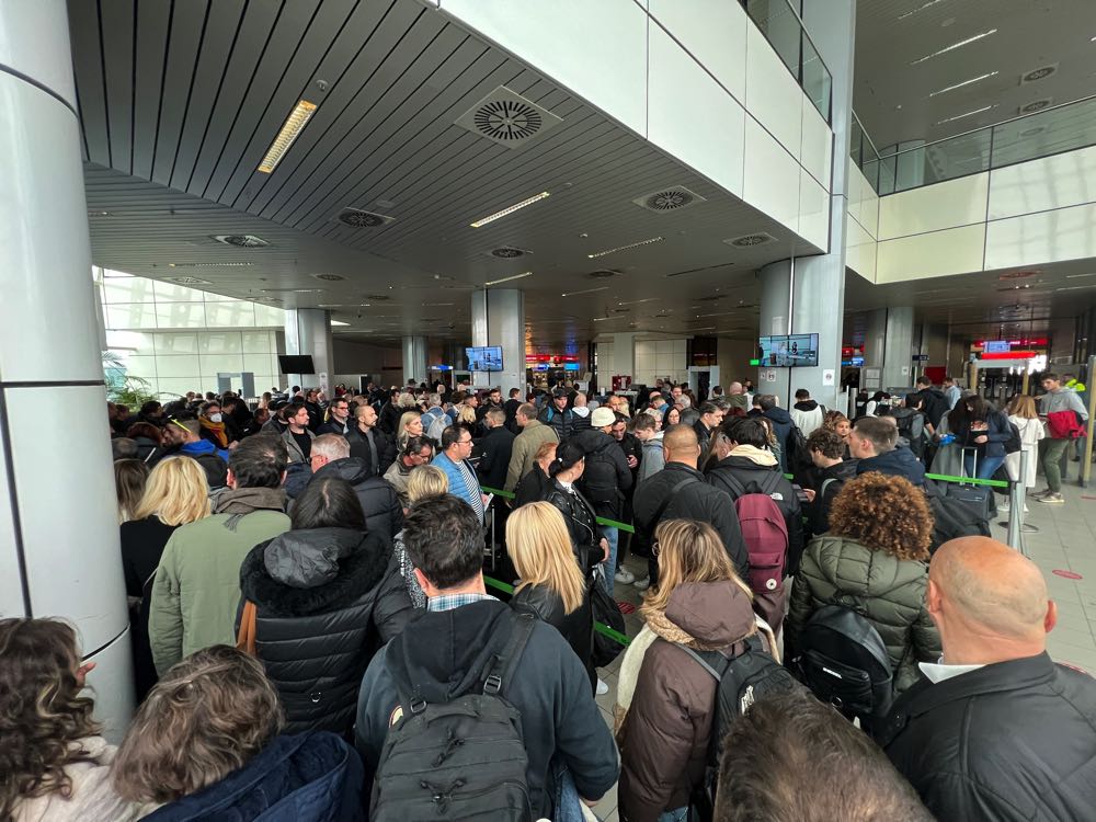 people waiting in line at the airport