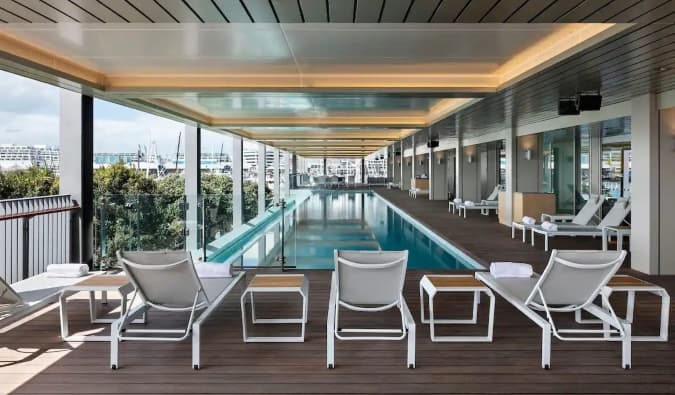 Outdoor pool surrounded by lounge chairs at Park Hyatt hotel in Auckland, New Zealand
