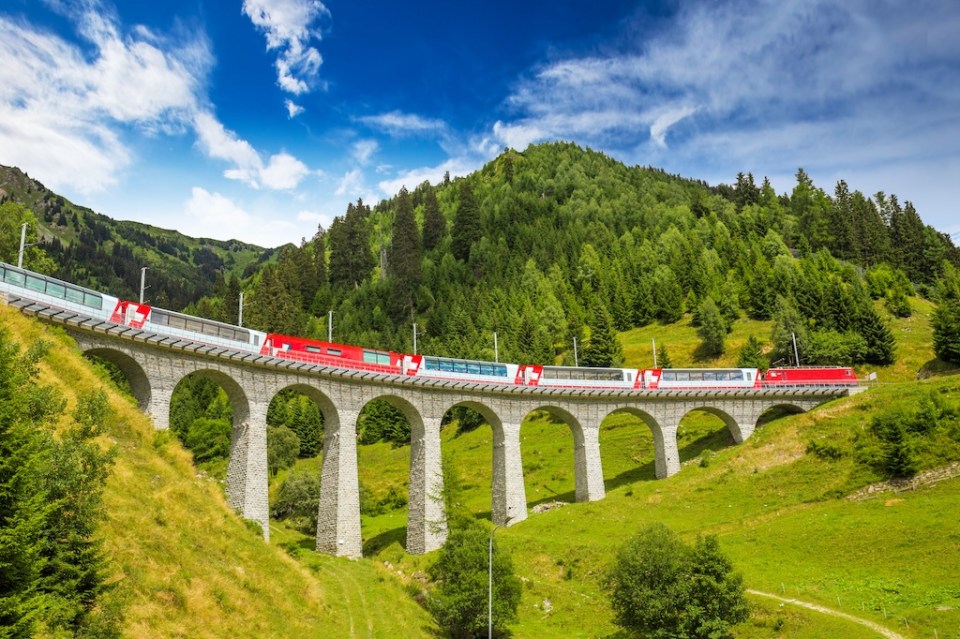 Train on famous landwasser Viaduct bridge.The Rhaetian Railway section from the Albula/Bernina area (the part from Thusis to Tirano, including St Moritz) was added to the list of UNESCO World Heritage Sites, Switzerland, Europe.