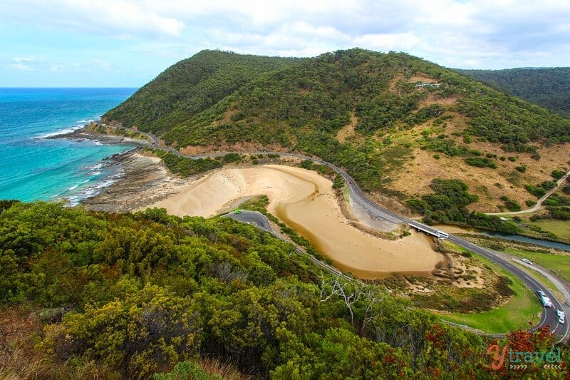 aerial view of winding great ocean road beside coast