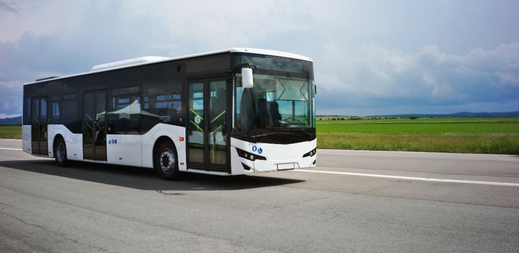 Shuttle bus on a highway on a sunny day. 