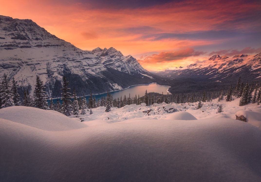 s snowy landscape with the sun sets