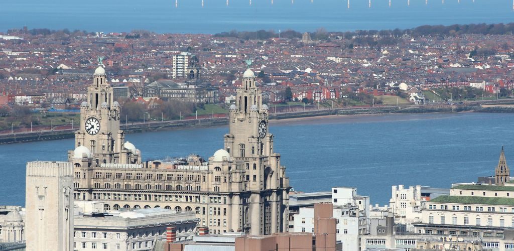 Liverpool city in Merseyside county of North West England (UK) Aerial view famous Royal Liver Building and offshore wind farm.