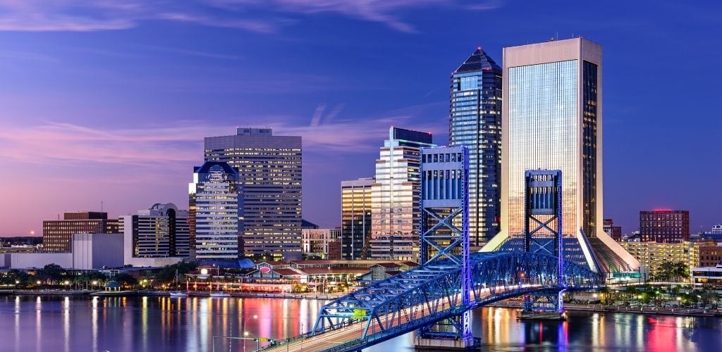 A beautiful buildings, city lights and a river.