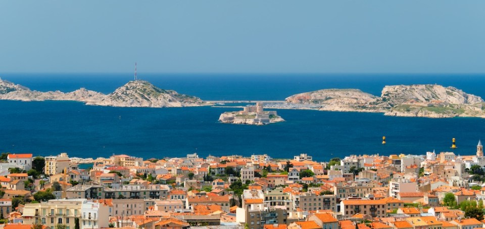 View of Marseille town and Chateau d'If castle famous historical fortress and prison on island in Marseille bay. Marseille, France