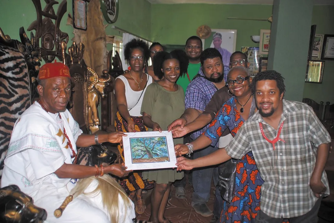 Brown and Roots to Glory travelers, many of Nigerian descent, present a painting to Eze Chukwuemeka Eri of Aguleri in Nigeria.