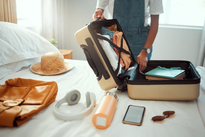 Woman packing clothes on a luggage