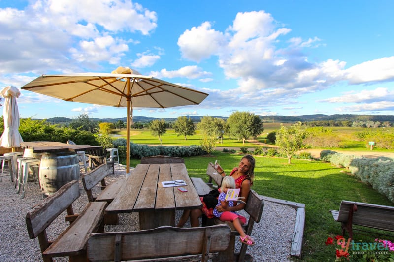 woman and child sitting at table with winery views