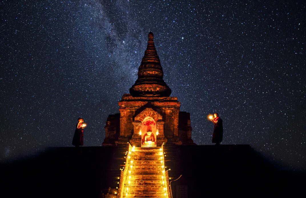 A nighttime ceremony is performed under a heavenly, star-filled sky.