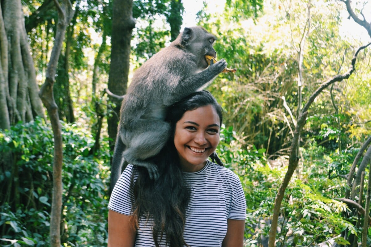 Me with a monkey on my shoulder in the ubud monkey forest in Bali, Indonesia