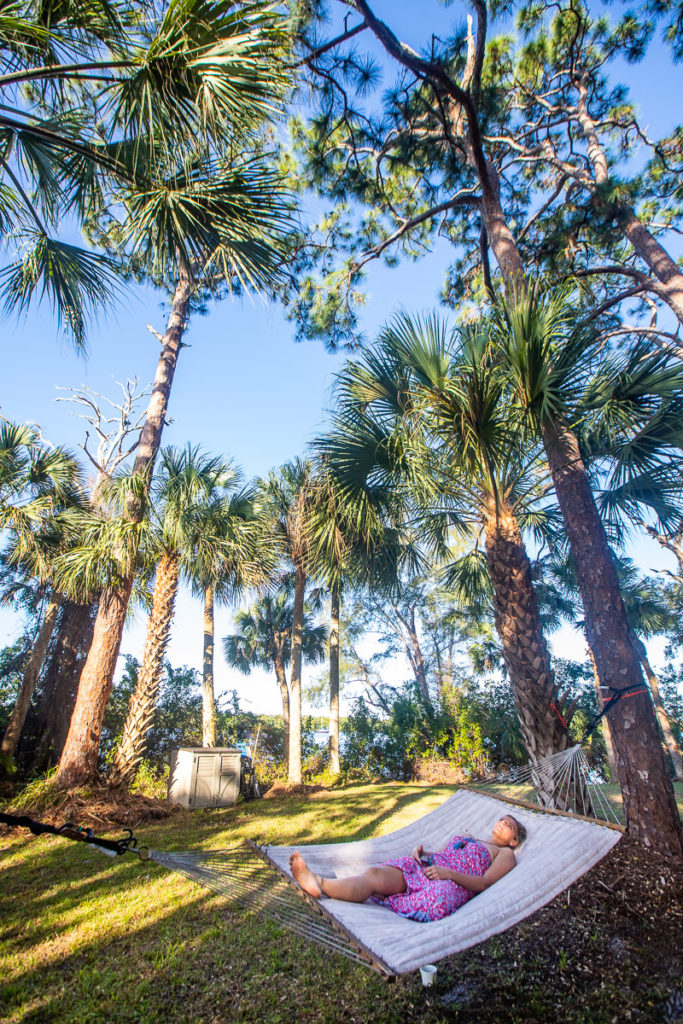 woman on hammock under palm trees