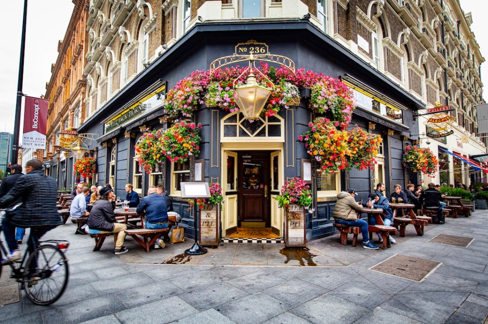 Old traditional Pub , Brewery, Bar entrance decorated with flowers in Central London, United Kingdom