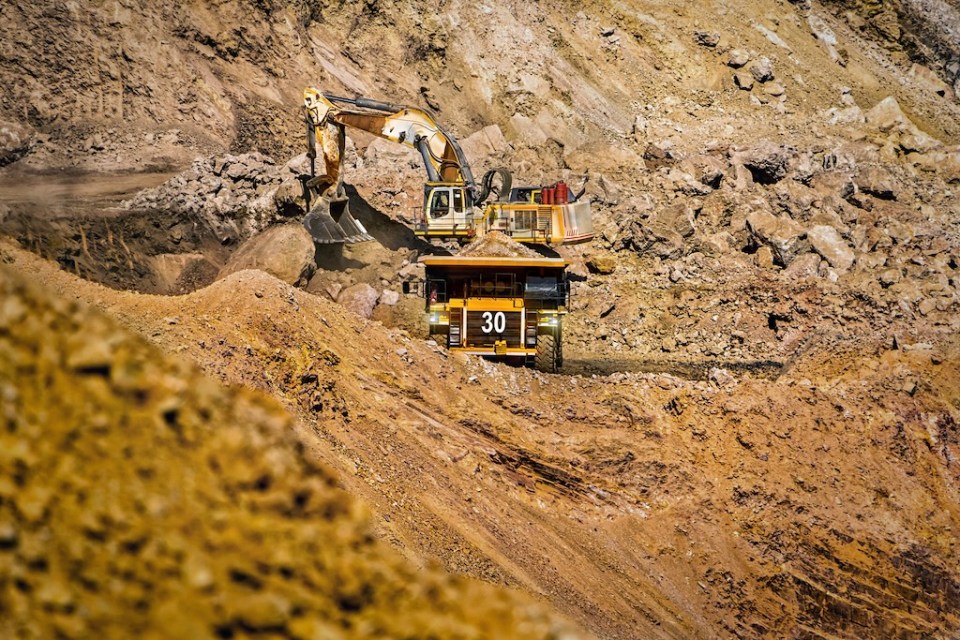 An open pit diamond mine in Botswana with heavy machinery on site.