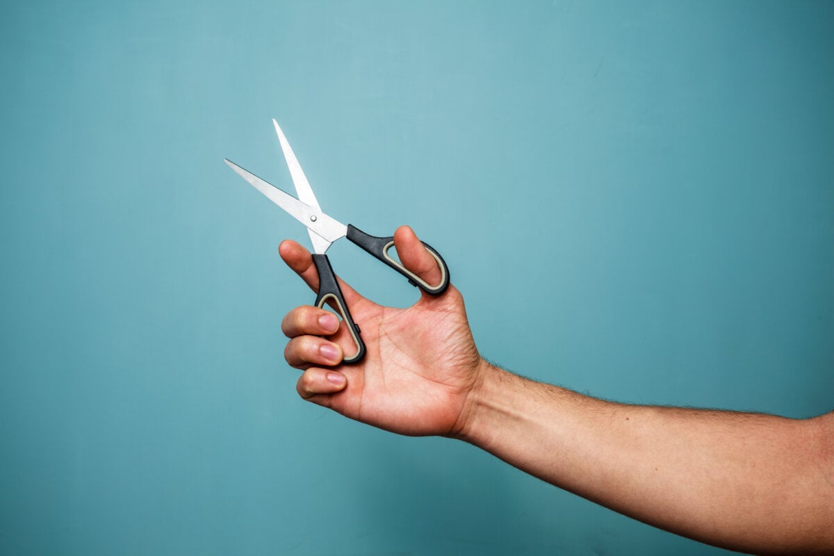Person holding scissors