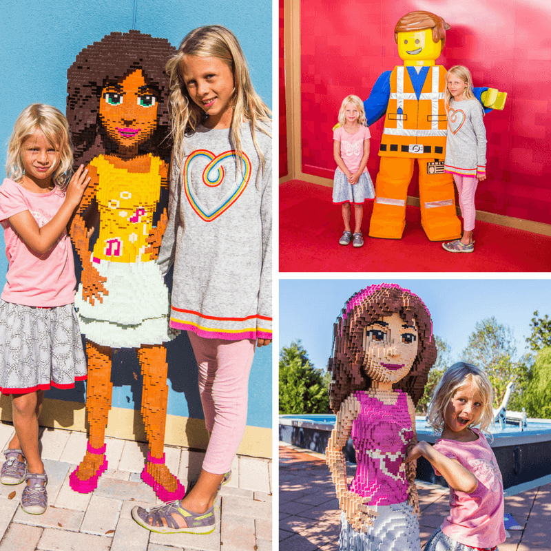 girls posing next to legoland figurines