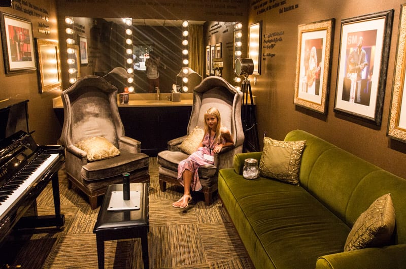 young girl sitting in chair in grand opry backstage room