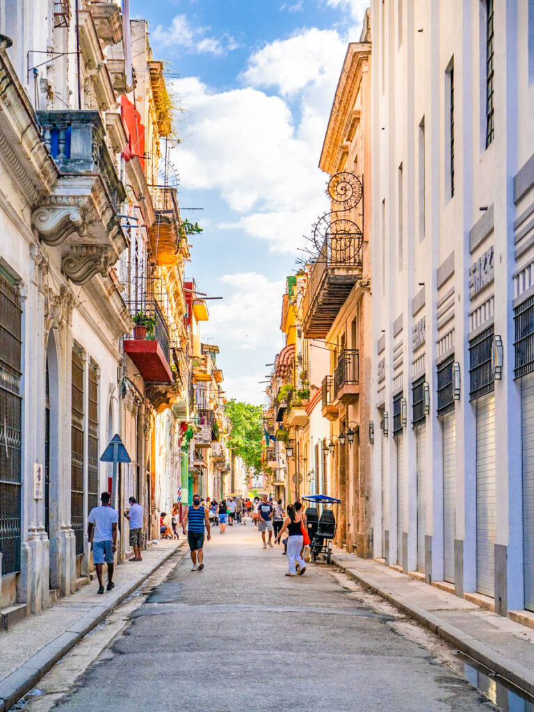 people walking on Old Havana street and its colonial buildings. Famous place and much visited by tourists