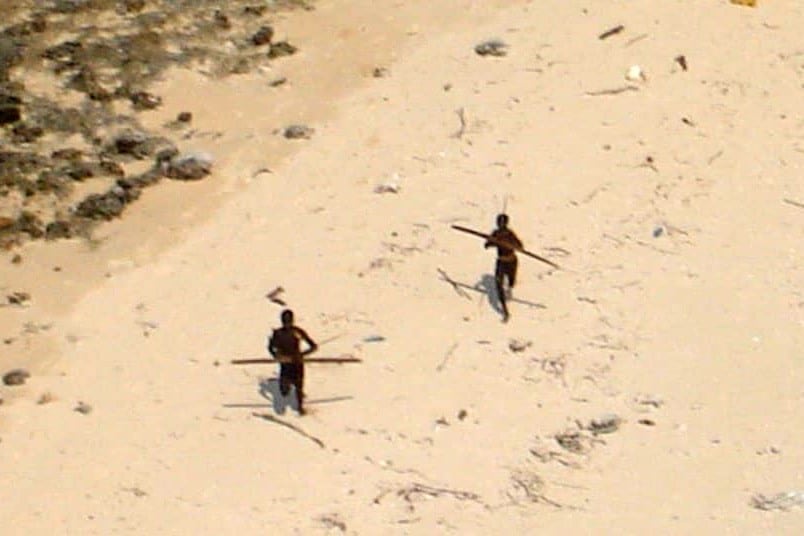 Tribesmen on North Sentinel Island take aim at an Indian Coast Guard helicopter