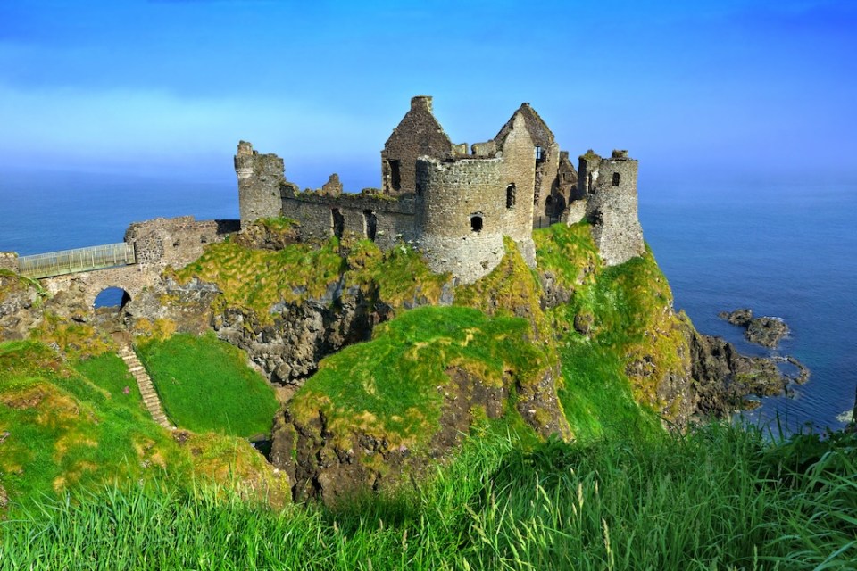 Ruins of the medieval Dunluce Castle overlooking the scenic cliffs of the Causeway Coast, Northern Ireland