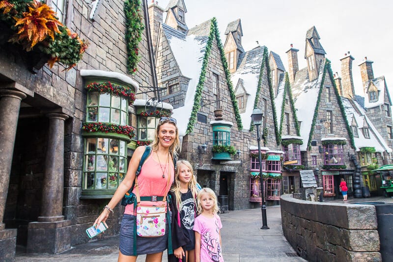 woman and two girls smiling in Hogsmeade Village at Universal Orlando Resort