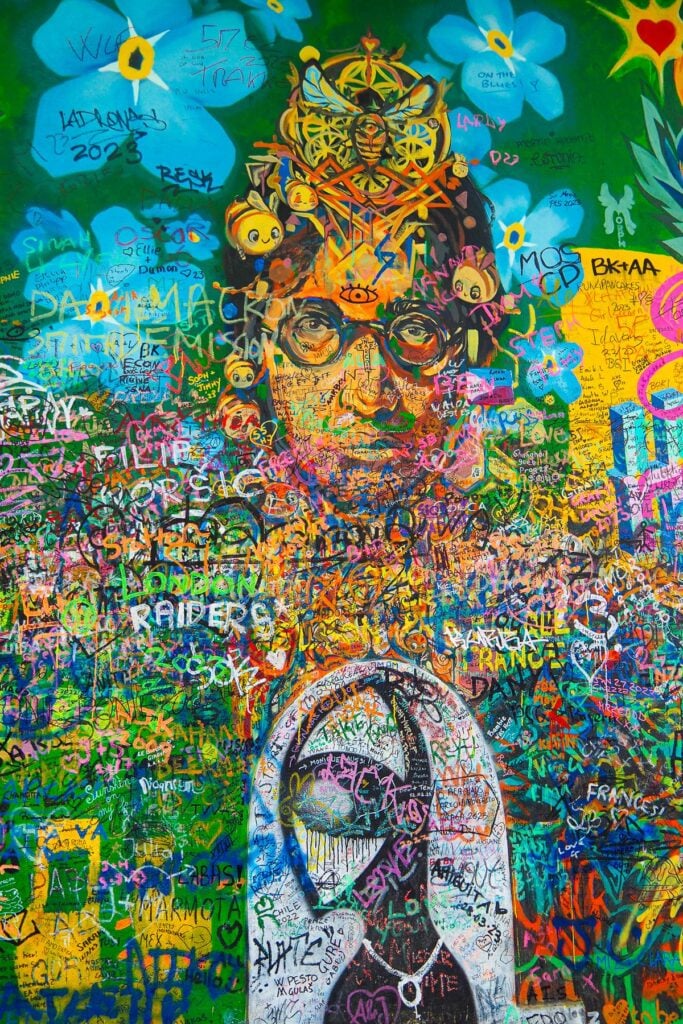 Colorful John Lennon mural at Lennon Wall Prague, a vibrant symbol of peace and art