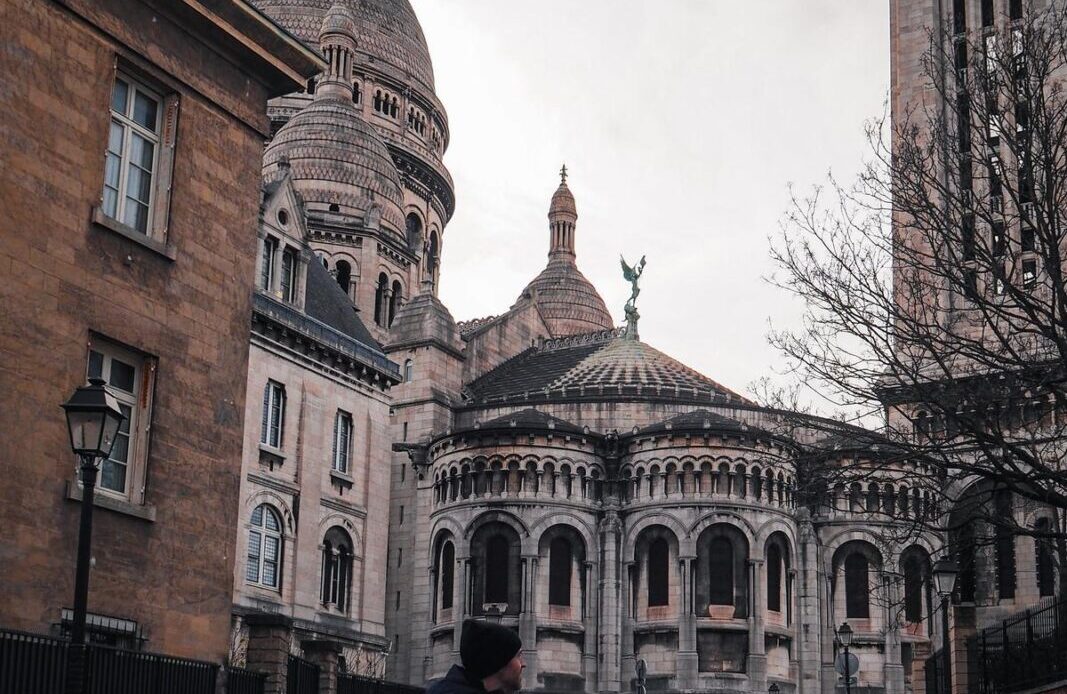 Traveler walking in Montmartre with Sacré-Cœur Basilica background