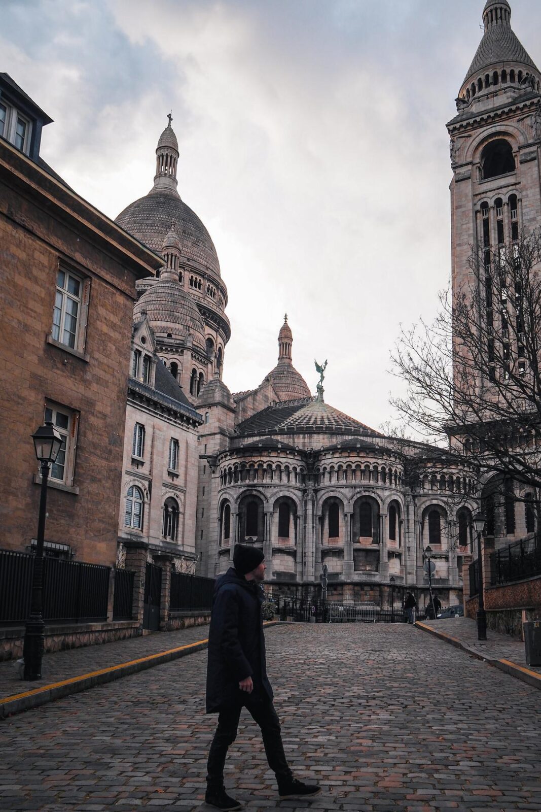 Traveler walking in Montmartre with Sacré-Cœur Basilica background
