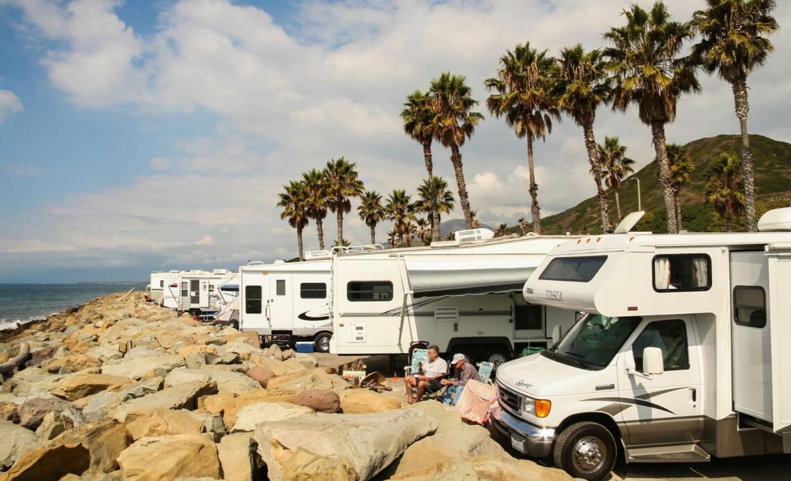 RVs parked along the ocean with palm trees - snowbird rental