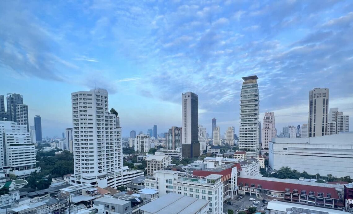 The towering skyline of downtown Bangkok, Thailand with a bright blue sky