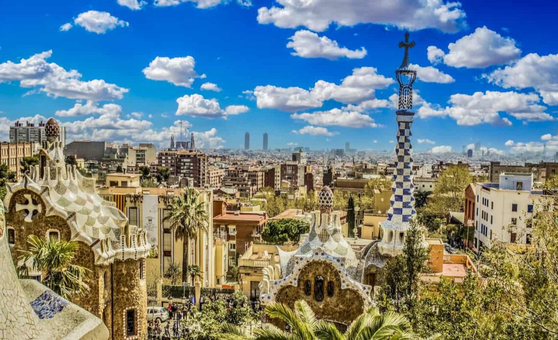 A blue sky over Park Guell in sunny Barcelona, Spain with the city skyline the background