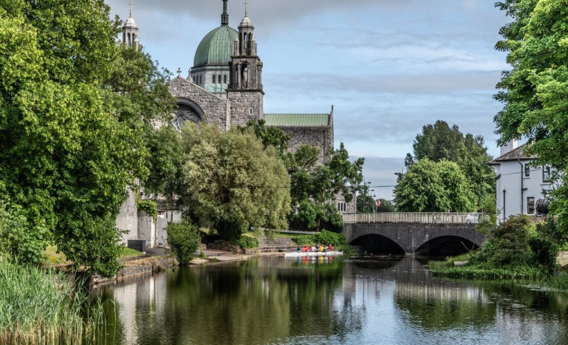 galway cathedral beyond lake and bridge in guide to things to do in galway ireland