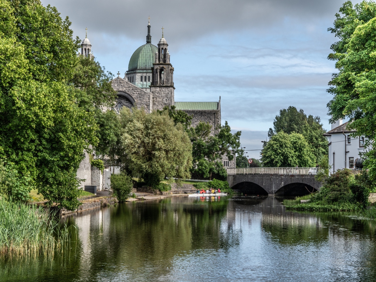 galway cathedral beyond lake and bridge in guide to things to do in galway ireland