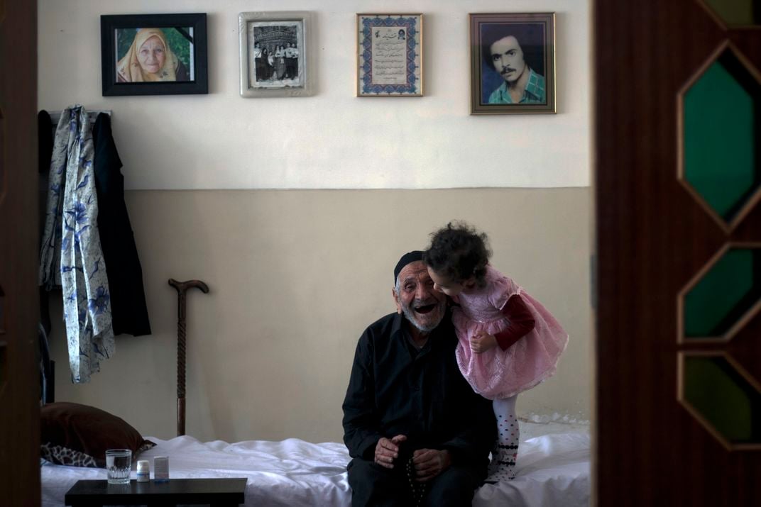 8 - Most people first learn about love as children from their parents and older relatives. They receive it, and then give it back. Here, a young girl plants a kiss on the cheek of her great-grandfather.