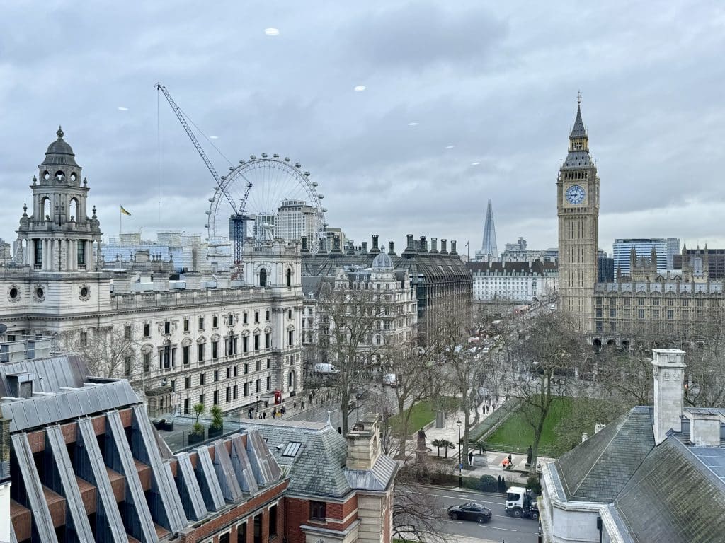 A view of London landmarks including Big Ben, the Shard, and the London Eye.