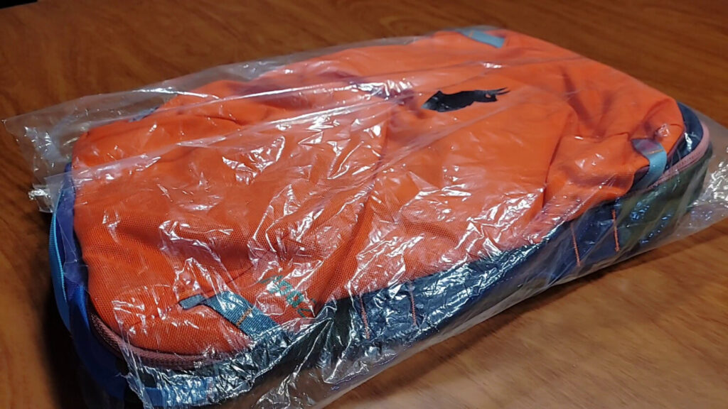 Cotopaxi backpack on a table wrapped in packaging