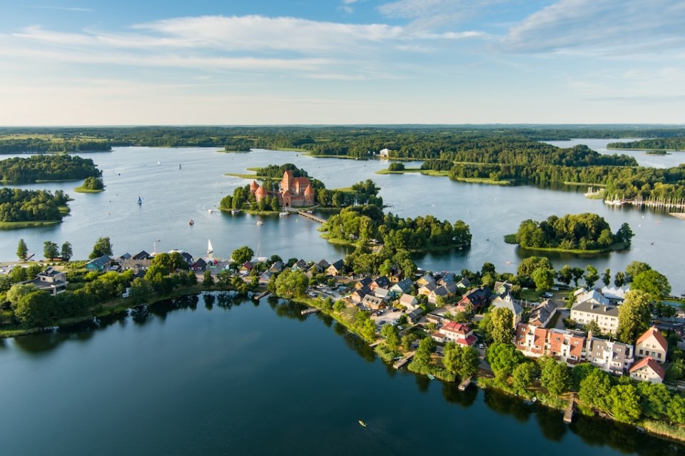 Aerial view of Trakai Island Castle and its surroundings, located in Trakai town, Lithuania. Beautiful view from the above on summer sunset.