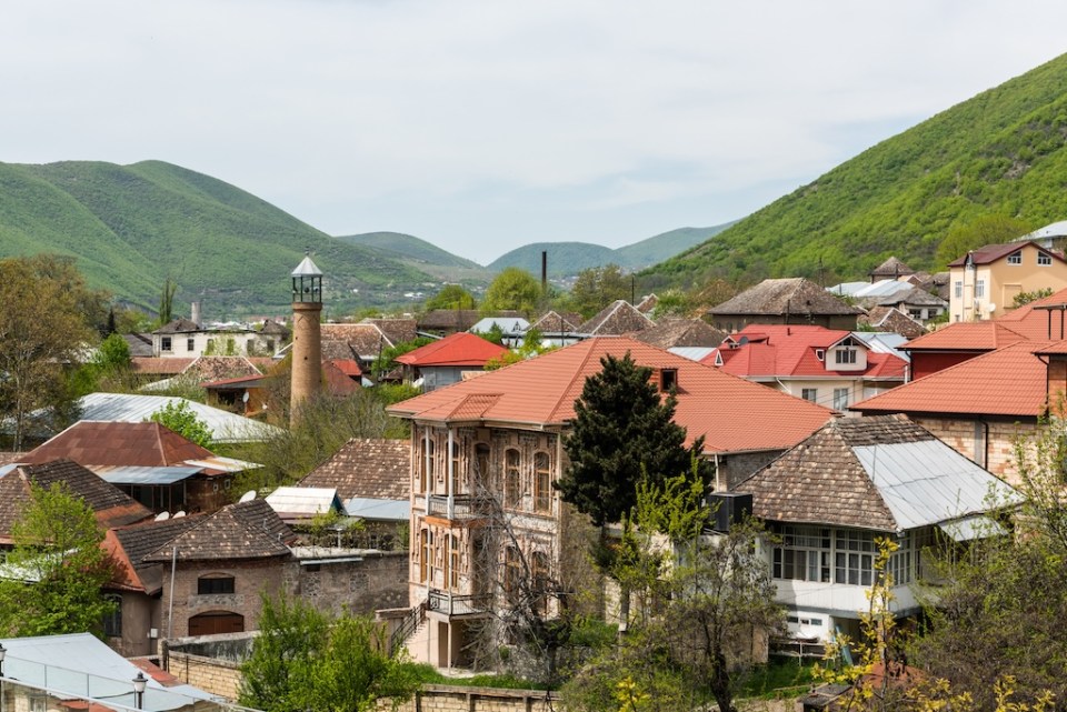 View over downtown area of Sheki town in Azerbaijan, with historical buildings and mosque.