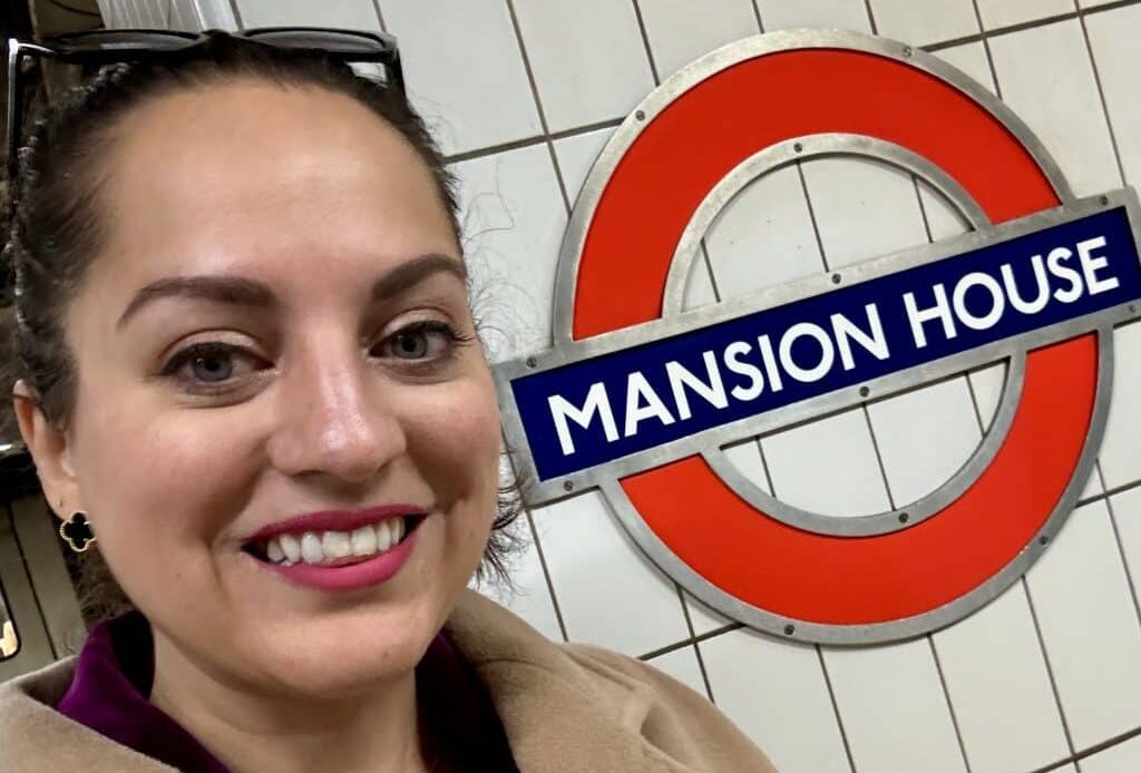 Kate taking a selfie next to the London Underground stop for Mansion House.