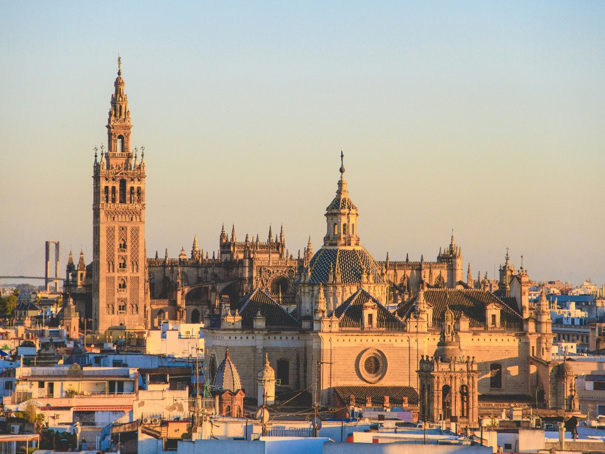 sunset view of seville, spain with many historic buildings.
