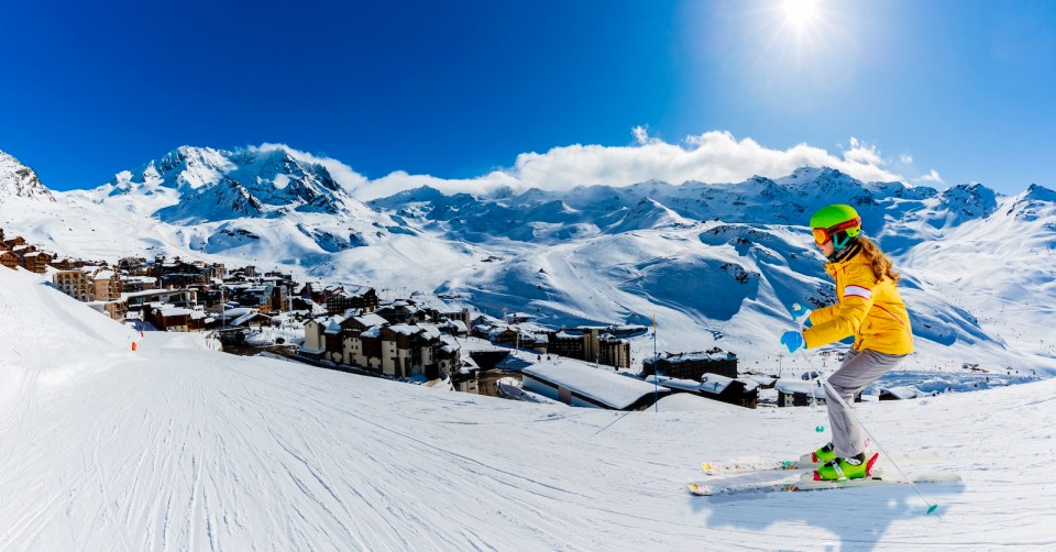 Ski in winter season, view from ski run at mountains and Val Thorens resort in sunny day in France, Alps.