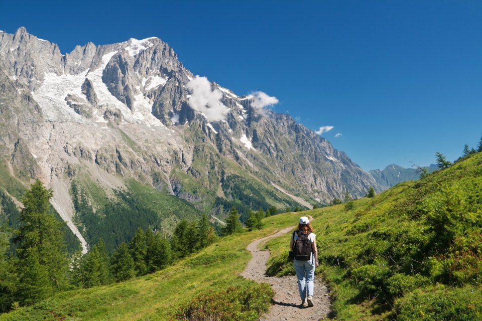 Hiker in action with Mont Blanc massif on the background