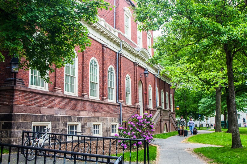 A bench in front of a brick building