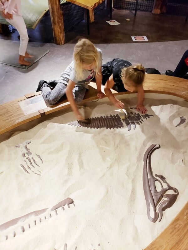 two girls digging in sandpit of Asheville museum of science