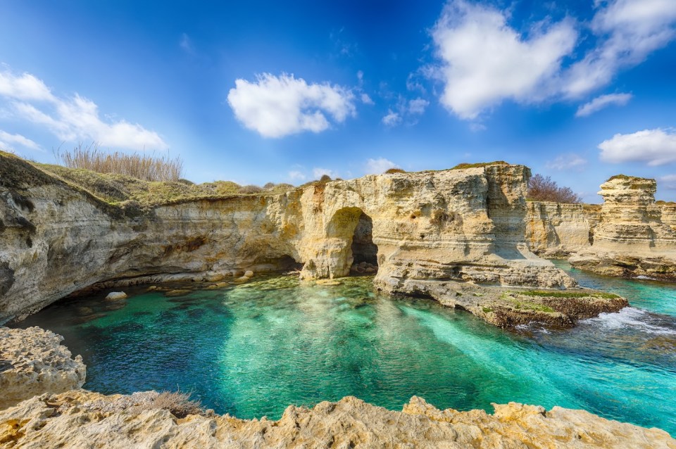 Picturesque seascape with cliffs, rocky arch at Torre Sant Andrea, Salento coast, Puglia region, Italy