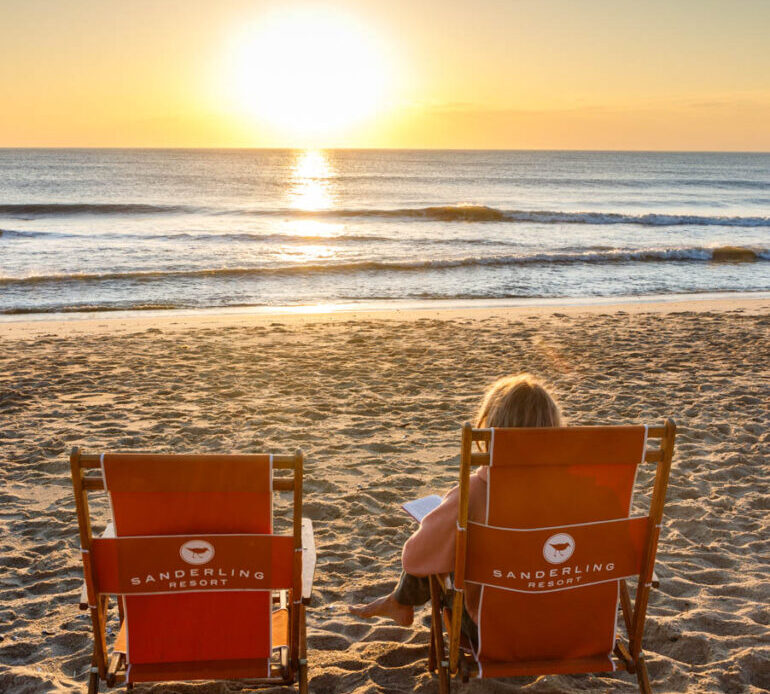 woman watching the sun rise at Duck beach