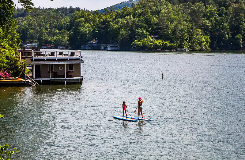 mother and child paddle boarding on lake lure, nc attraction